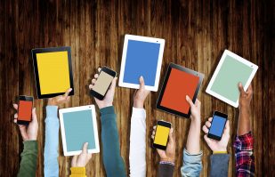 group of hands holding devices